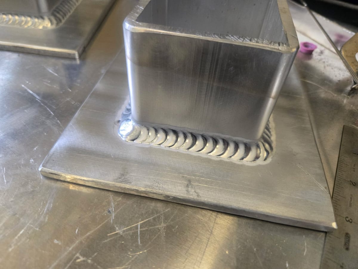 Close-up of a clean stacked-dime TIG fillet weld on aluminum